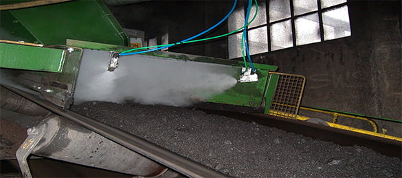 A second Image of a conveyor with dust suppression spray in operation